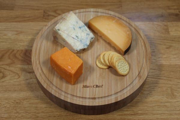 Round bamboo cheese board with grapes and cheese — view 2